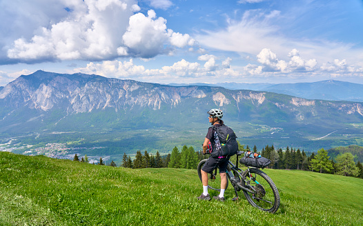 active senior woman on a mountain bike tour in the carinthian alps above Villach