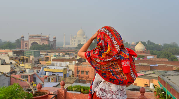 istock A young woman looking at Taj Mahal 1502918084