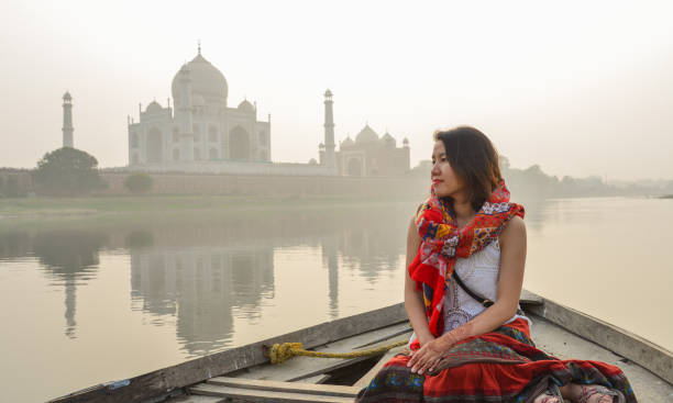 istock A woman watching sunset over Taj Mahal 1502919335