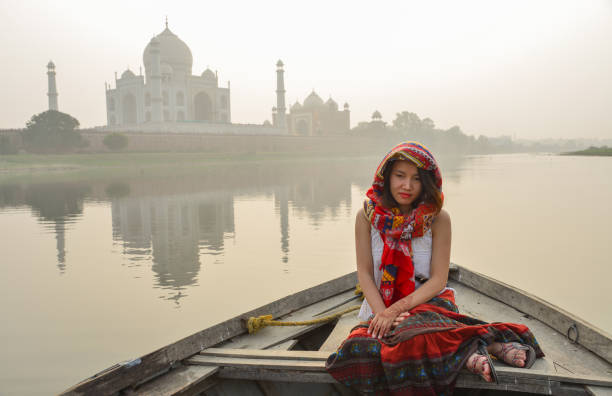 istock A woman watching sunset over Taj Mahal 1502919463