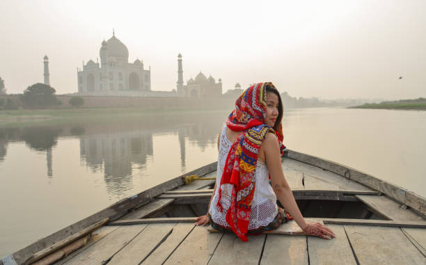 istock A woman watching sunset over Taj Mahal 1502919466