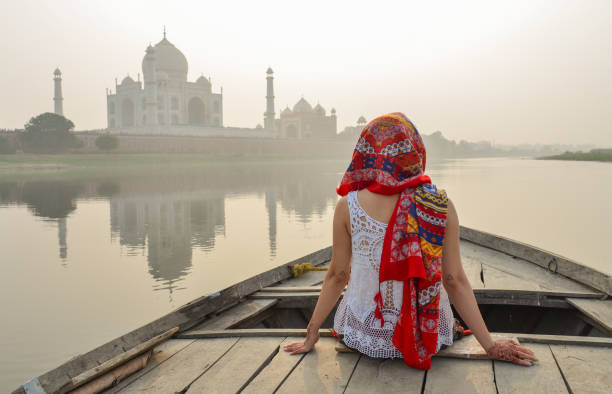 istock A woman watching sunset over Taj Mahal 1502919491
