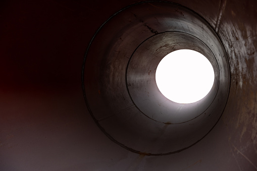 Black sphere travelling inside of a tunnel. Horizontal composition.