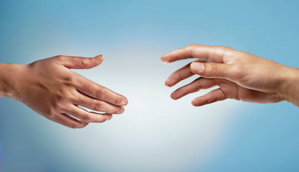 istock Reach out to someone. Hands reaching towards each other. 1502923595