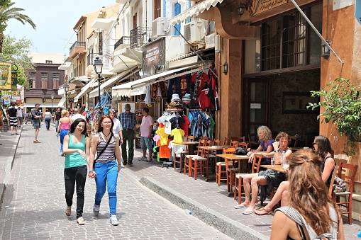 People shop in Old Town in Rethymnon, Crete, Greece. It is the 3rd largest city of the island. Crete attracts 2.8 million annual tourists (2011).