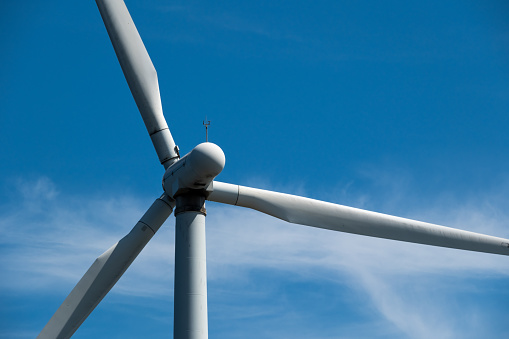 Wind turbine farm against blue sky
