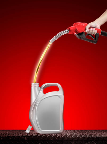 istock Hand holding plastic gallon refill dispenser placed on metal background isolated on red background 1502926881