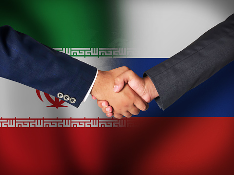 Iran and Russia Friendship concept background with waving flags and handshake.