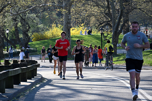 New York, USA, April 13, 2023 - tourists, joggers, walkers and cyclists in the Central Park New York.