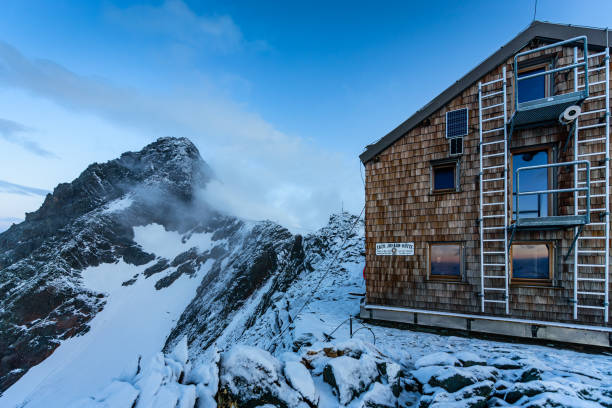 Amidst the unexpected beauty of summer, a snowy alpine landscape unfolds high atop mountain summits. Nature's contrasting elements create a serene panorama, where lush greenery meets lingering snow, crafting a picturesque scene in the heart of the Swiss mountains.