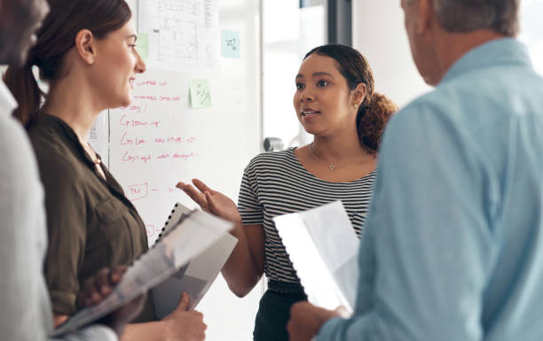 istock Business people, documents and group at startup with discussion, teamwork and planning strategy for proposal. Men, women and paperwork for brainstorming, collaboration and together for ideas at job 1502930608