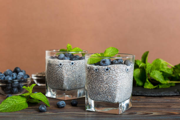 istock Healthy breakfast or morning with chia seeds vanilla pudding and blueberry berries on table background, vegetarian food, diet and health concept. Chia pudding with coconut milk and blueberry 1502932947