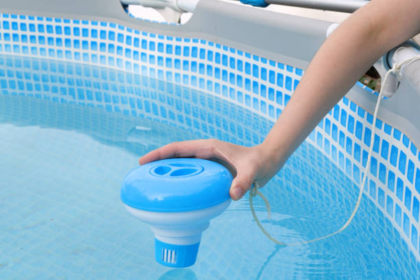 istock Worker hands isinfection and chlorination of water in the pool. Purification from pollution pool chlor dispenser 1502933026