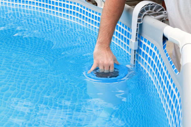 istock Man cleans skimmer for the frame pool. Contaminated pool cleaning concept 1502933033