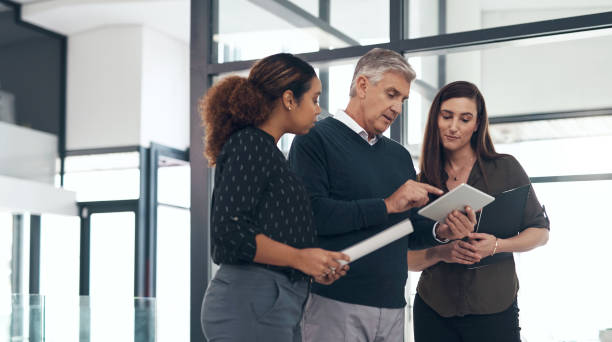 istock Communication, people planning and with tablet together in their modern workplace for support. Coaching or networking, collaboration or teamwork and coworkers with discussion of data review. 1502935719