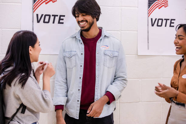 Diverse friends smile and laugh after voting