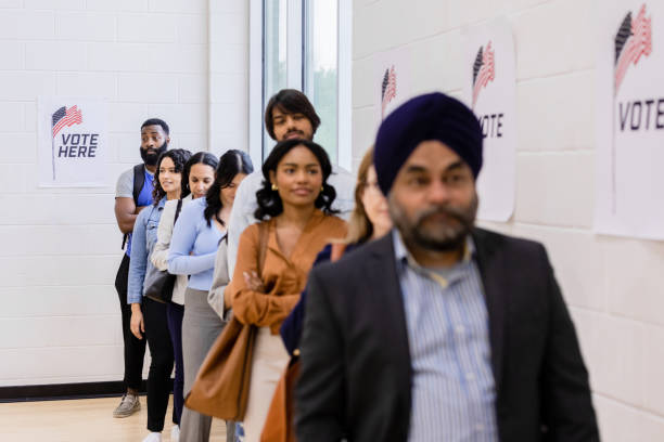 istock Multiracial group waits patiently to vote in election 1502936688