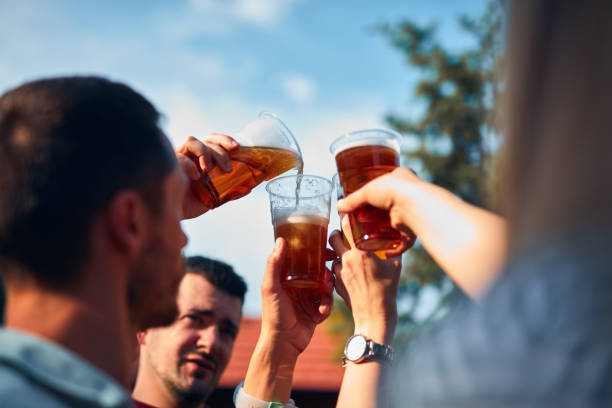 istock Group of friends enjoying cold beer at a backyard party. 1502937006