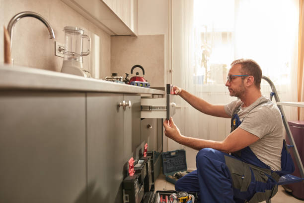 istock Handyman fixing kitchen cabinets in the apartment. 1502937236