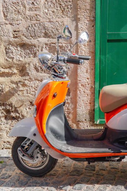 istock Orange motorcycle in front of green window 1502937564