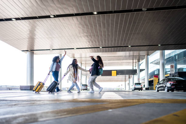 istock Friends celebrating while walk at the airport 1502937764