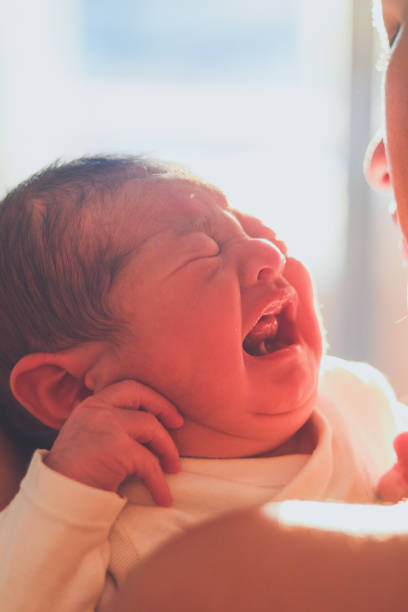 istock Baby crying in mother's arms 1502939173