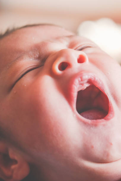 istock Newborn baby face yawning 1502941000