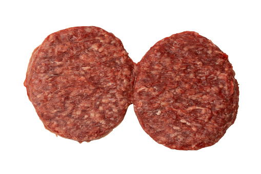 Raw meat beef burgers viewed from above - white background