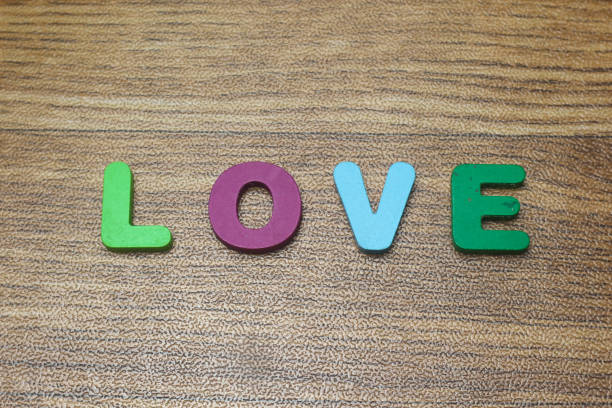 Wooden letters is forming one word LOVE