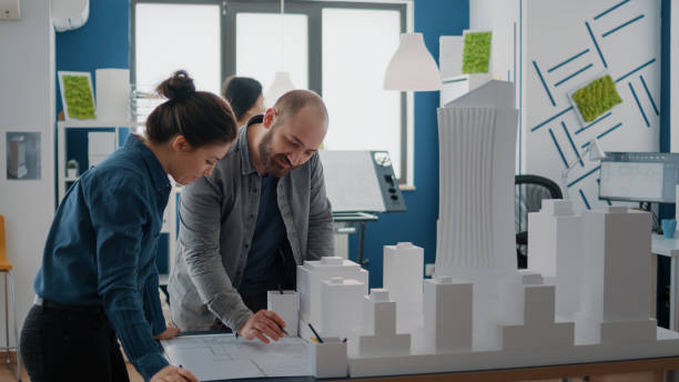 istock Team of colleagues using building model for inspiration to design construction layout 1502942403