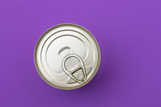istock Unopened Tin Can with Blank Edge on Violet Background 1502942823
