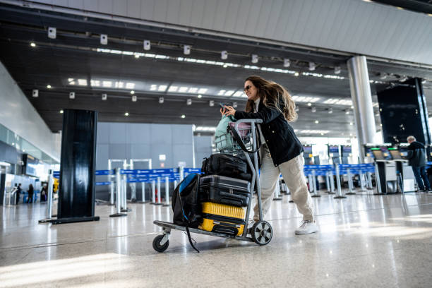 istock Young woman using phone at the airport 1502942944