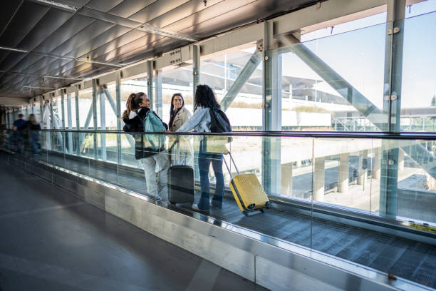 istock Friends talking in escalator the airport 1502943294