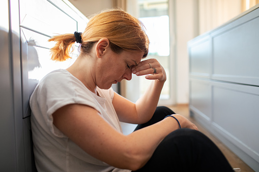 Close up of a Mid adult woman taking a break from cleaning the house