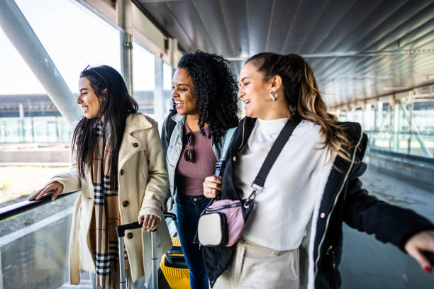 istock Friends talking while look through window in escalator the airport 1502943354