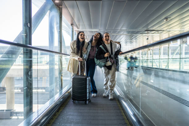 istock Friends talking in escalator the airport 1502943365