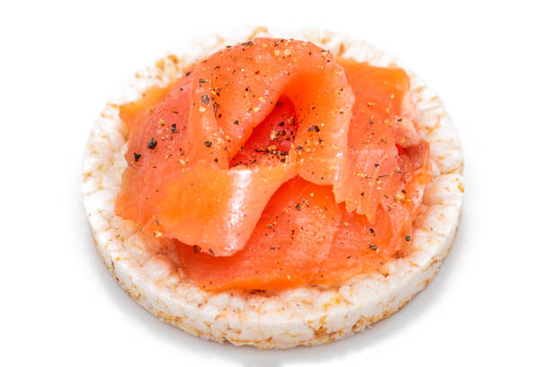 istock Rice Cake Sandwich with Fresh Salmon Slices Isolated on White 1502944702