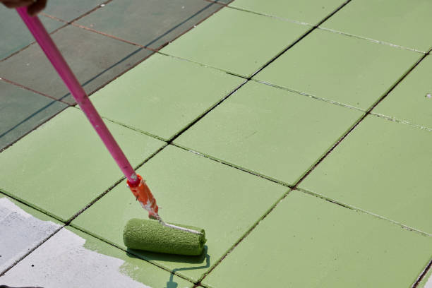 istock Paint roller and painting green color on wall 1502944808