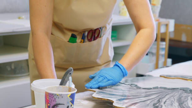 istock woman is creating a resin artwork in a creative workshop 1502945008