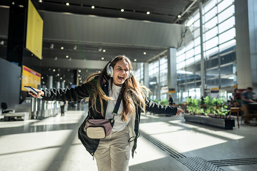 Young woman dancing at the airport