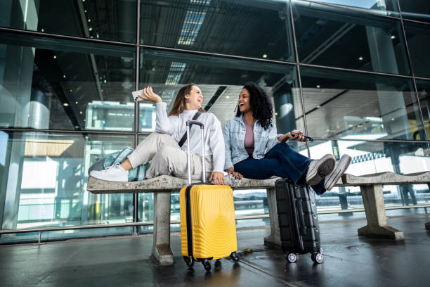 istock Friends talking while waiting at the airport 1502945405
