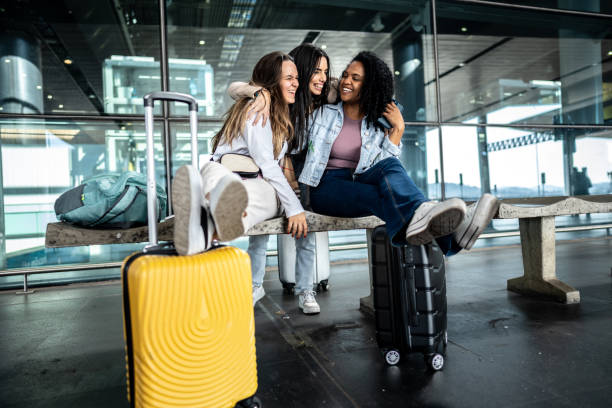 istock Friends embracing while talk at the airport 1502945455