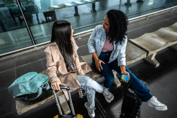 istock Friends talking while waiting at the airport 1502945499
