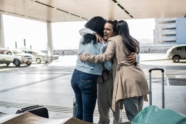 istock Friends embracing at the airport 1502945695