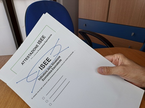 Equivalent Economic Situation Indicator Form Modello ISEE. Man hand holds sheet.