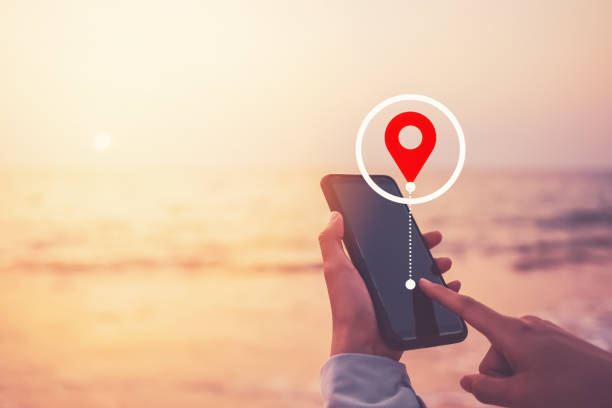 istock Woman hand using smart phone with navigator location point at tropical sunset beach abstract background. Technology interenet and travel adventure concept. Vintage tone filter effect color style. 1502946790