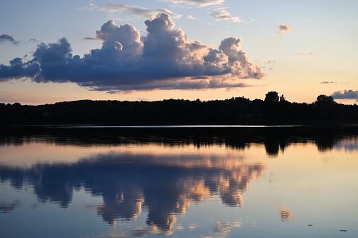 Summer sunset over a lake. The last rays of the setting sun