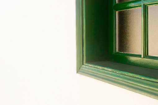 Closed green window on white wall. Lanzarote, Canary islands, Spain.