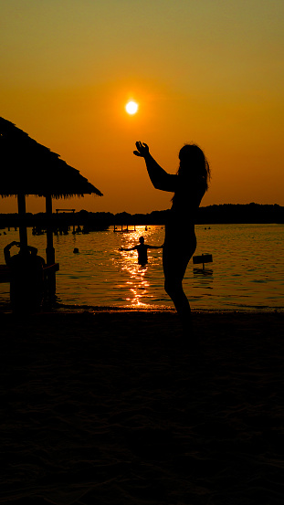 silhouette photo enjoying sunset on the beach