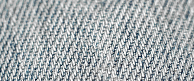 Close-up of a fabric textile texture as background. Macro of blue-white fabric cloth